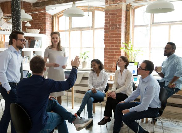 Male worker raise hand asking question at office teambuilding