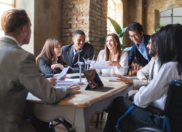 Group of multiethnic businesspeople discussing about financial strategy, renewable power, sustainable innovation project and environmental economical issues - business, sustainability interracial lifestyle concept