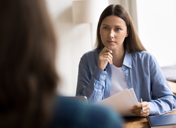 Serious female HR manager interviewing woman applicant