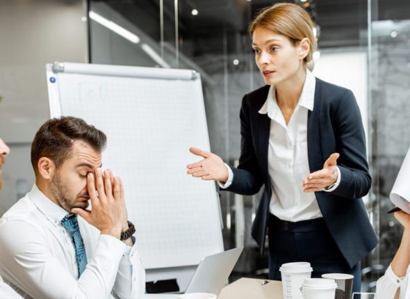 Boss quarreling at employees during a conference