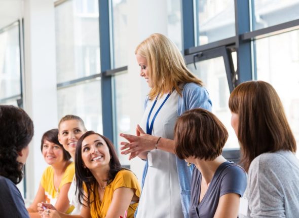 A group of people sitting around a table engaged in a workshop.