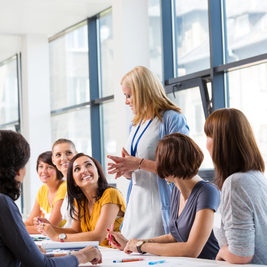 A group of people sitting around a table engaged in a workshop.
